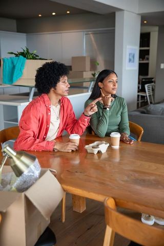 Diverse Couple Discussing Plans in Contemporary Apartment