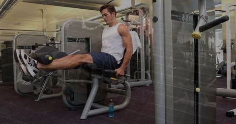 adult male using leg extension machine in fitness center - Download Free Stock Images Pikwizard.com