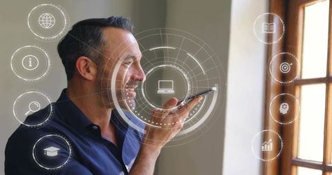 Man speaking into smartphone controlling futuristic hud interface by window for remote work