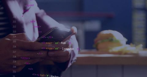 Developer scrolling html on smartphone while eating lunch in cafe with burger and fries