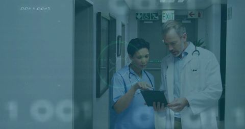 Doctor and Nurse Reviewing Patient Data on Tablet in Hospital Corridor with Digital Overlay
