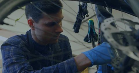 Mechanic Adjusting Bicycle Disc Brake in Workshop, Maintenance and Repair Concept