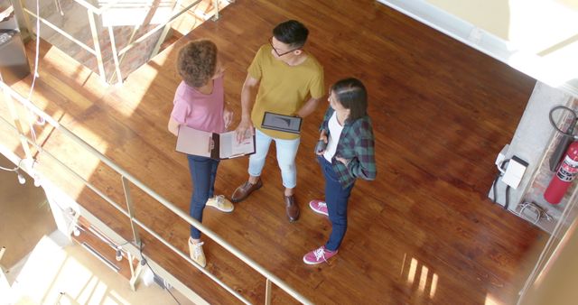 Young professionals collaborating in modern office space from above - Download Free Stock Images Pikwizard.com