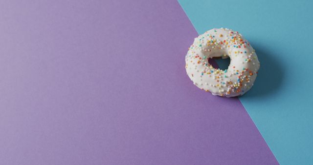 White Frosted Donut with Sprinkles on Split Pastel Background - Download Free Stock Images Pikwizard.com
