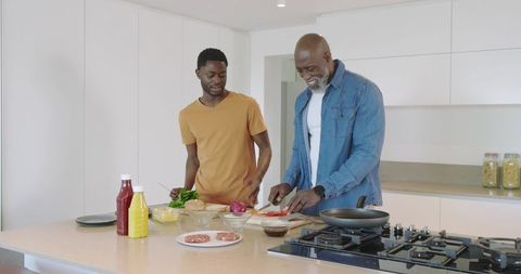 Father and Son Preparing Meal in Modern Kitchen