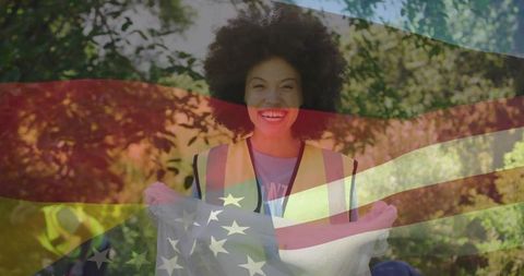 Smiling Volunteer Cleaning Park Holding Trash Bag