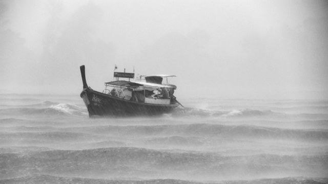 Black Boat Sailing While Raining - Download Free Stock Photos Pikwizard.com
