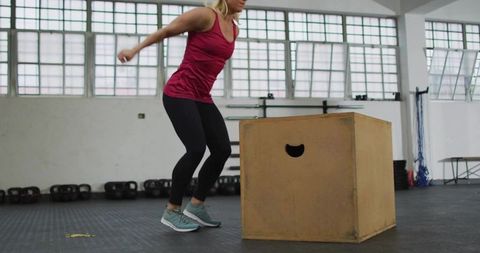 Athletic Woman Preparing for Box Jump in Gym