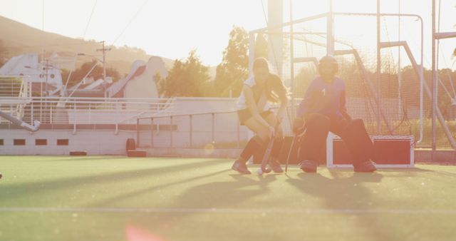 Girls Playing Field Hockey During Sunset on AstroTurf Field - Download Free Stock Images Pikwizard.com