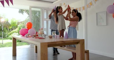 Family Celebrating Birthday with Decorated Party Setup