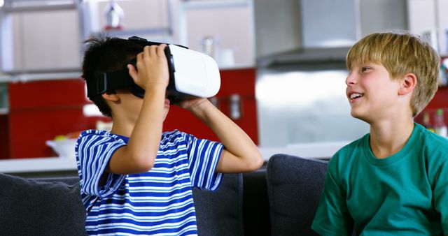 Boys playing with VR headset in living room. Great for illustrating modern technology use among children, family activities, and home entertainment. Suitable for educational, technology-focused, and lifestyle content.