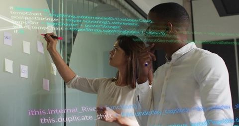 Collaborating on glass board with sticky notes, pink marker and transparent code overlay