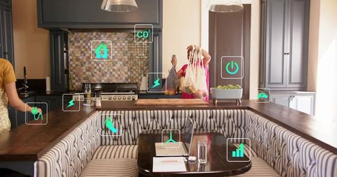 Unpacking groceries in modern smart kitchen by mature south asian woman in sari