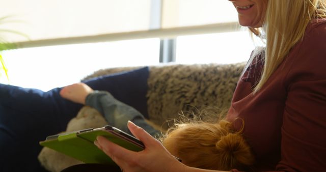 Mother and Child Using Tablet on Couch with Soft Light - Download Free Stock Images Pikwizard.com