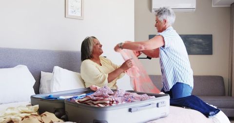 Senior Lesbian Couple Packing for Vacation