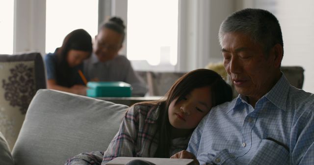 Grandfather Reading with Granddaughter in Cozy Living Room - Download Free Stock Images Pikwizard.com