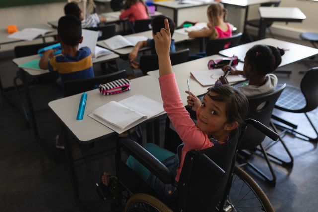 Disable schoolgirl in a wheelchair raising hand during a classroom session, highlighting inclusive education and diversity. Ideal for illustrating concepts of accessible education, student participation, and classroom learning environment in elementary schools. Useful for educational materials, promotional content for inclusive learning, and social campaigns emphasizing equality and diversity in education.