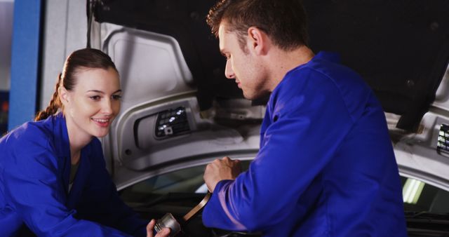 Mechanics Working Together on Car Engine Inside Garage - Download Free Stock Images Pikwizard.com