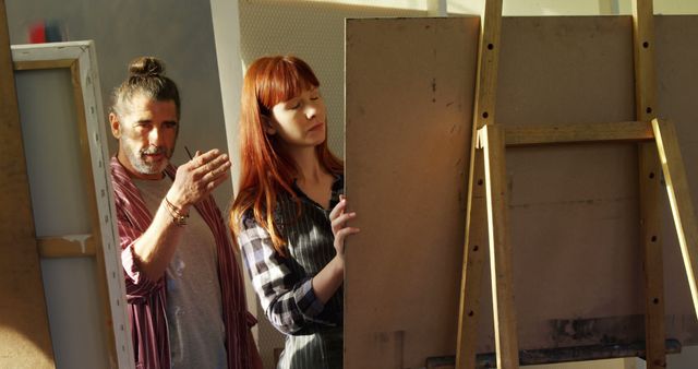 Art Instructor Teaching Young Woman Painting Techniques in Studio - Download Free Stock Images Pikwizard.com
