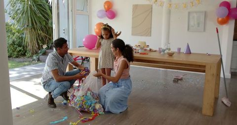 Family Cleaning Colorful Party Decor with Smiles and Teamwork at Home