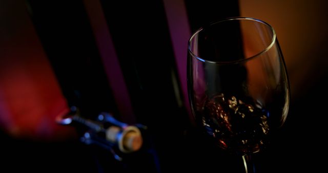 Close-up of Wine Glass on a Dark Background with Bottle - Download Free Stock Images Pikwizard.com