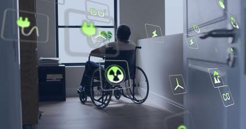 Senior man in wheelchair contemplating window while smart energy icons float