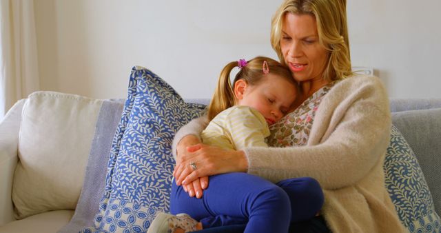 Grandmother comforting granddaughter on cozy couch at home - Download Free Stock Images Pikwizard.com