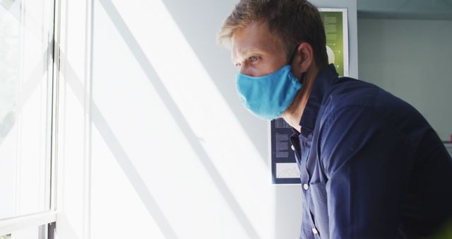 Concerned Man Wearing Mask Looking Out Window - Download Free Stock Images Pikwizard.com