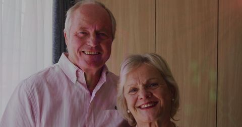 Elderly Couple Smiling at Home Representing Technology