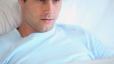 Man Relaxing with Laptop Browsing in Casual Home Environment