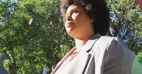 Confident plus size professional engaging with smartwatch outdoors