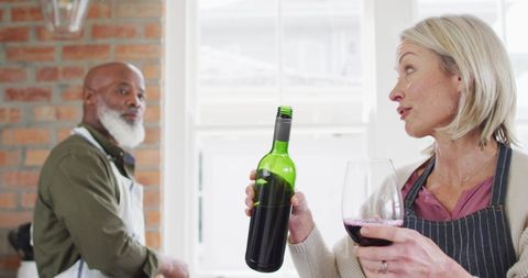 Senior Couple Enjoying Wine in Cozy Home Kitchen - Download Free Stock Images Pikwizard.com