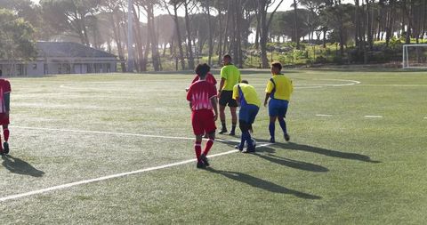 Teen Soccer Players Practicing on Grass Field with Focus