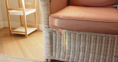 Cozy wicker armchair with rainbow hues and minimalist decor