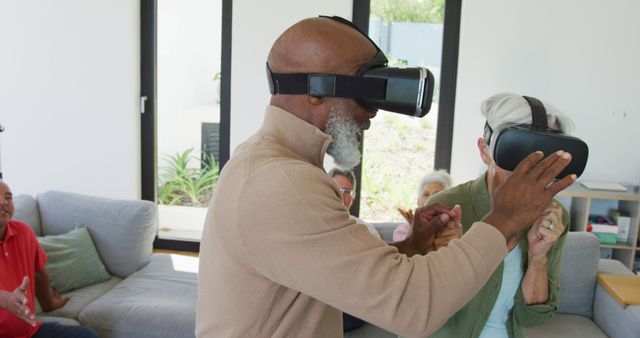 Seniors Enjoying Virtual Reality Experience Together in Modern Living Room - Download Free Stock Images Pikwizard.com