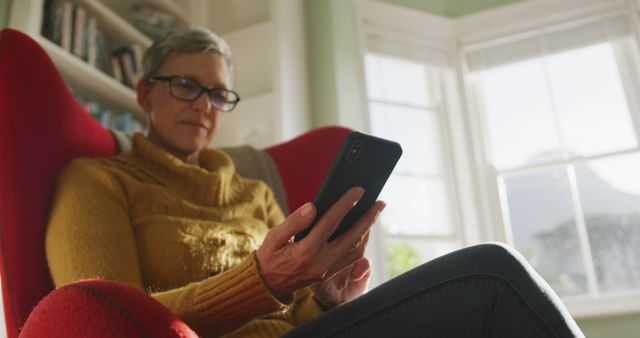 Senior Woman Enjoying Smartphone in Cozy Living Room - Download Free Stock Images Pikwizard.com