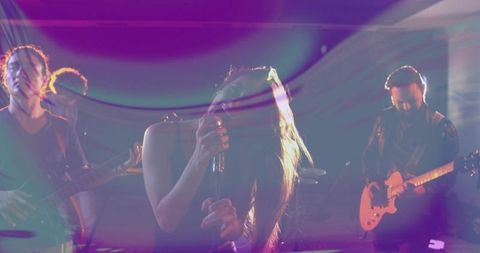 Dynamic band stage performance with vocalist under colorful lights