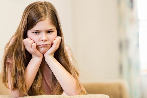 Thoughtful Young Girl Relaxing in Cozy Living Room