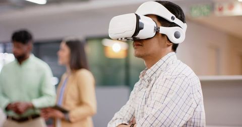 Man using virtual reality headset in innovative office