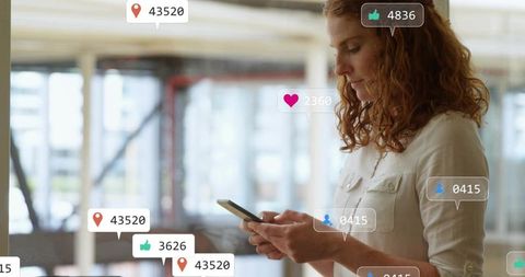 Red-haired woman checking smartphone in modern office with social media engagement icons