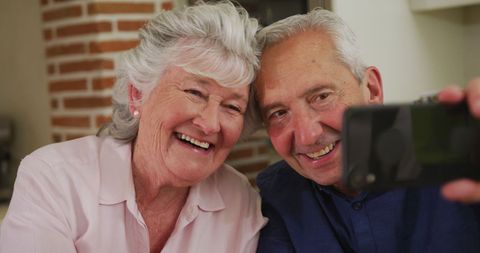 Elderly Couple Taking Selfie Together at Home