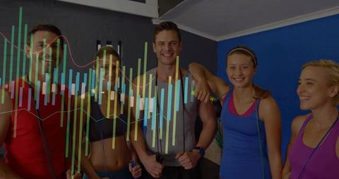 Group fitness team holding jump ropes smiling and celebrating cardio workout success