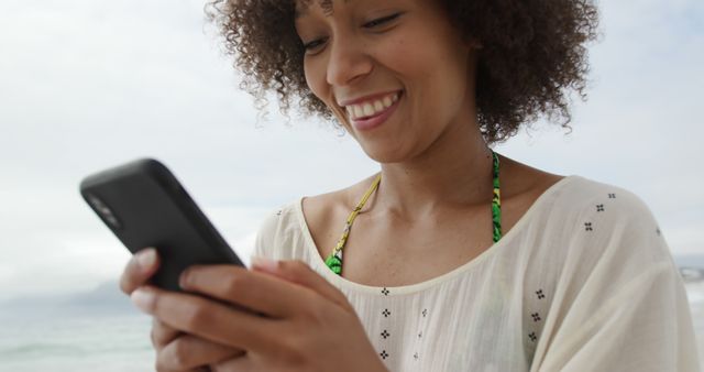 Cheerful Woman Texting on Smartphone While Enjoying Beach Vacation - Download Free Stock Images Pikwizard.com