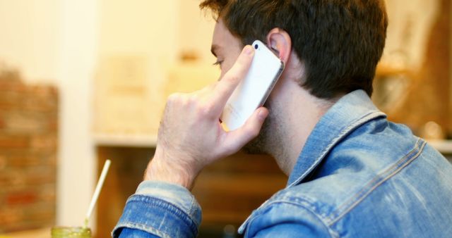 Man Talking on Smartphone in Casual Setting - Download Free Stock Images Pikwizard.com