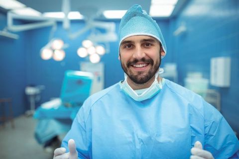 Smiling Surgeon in Operating Room with Surgical Equipment