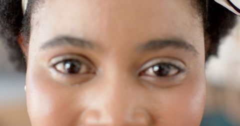 Close-Up of Warm Smiling African American Woman with Brown Eyes Indicating Personal Connection