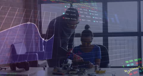 Teacher Guides Student in Technology Learning with Stock Market Data Overlay