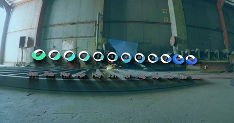 Welder Working in Industrial Factory with Flying Sparks