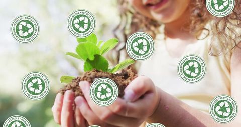 Young girl holding seedling with recycle symbols promoting sustainability