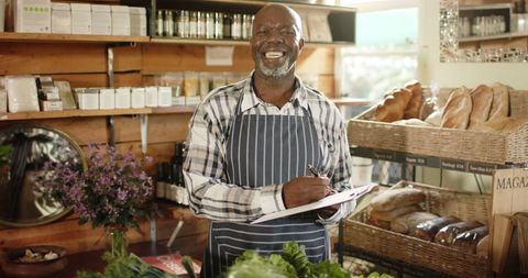 Cheerful Shopkeeper Managing Inventory in Health Food Store